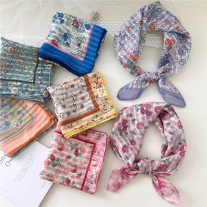Floral cotton linen square scarves collection in vibrant colors on a clean white table
