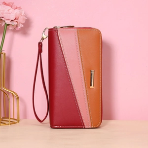 Vertical view of a multi-color long women's wallet with hand strap on wooden surface