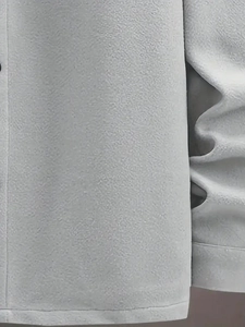Detail shot of grey fleece fabric texture with soft pile finish and visible stitching