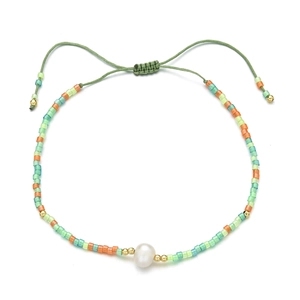 Detail of adjustable woven cord bracelet with colorful beads and a central freshwater pearl