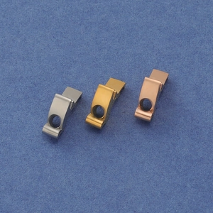 Macro shot of curved stainless steel clasps in silver, gold, and rose gold finishes