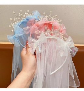 Detailed view of girls princess crown headbands with tulle veils in blue pink and white