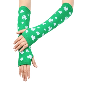 Detail of green knit fingerless arm warmers with white shamrock pattern on wrists