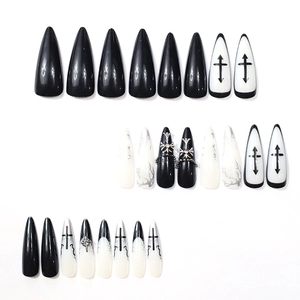 Gothic black and white stiletto press-on nails set with silver cross and flame design