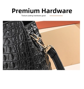 Detailed macro shot of textured crocodile leather and golden plating hardware on handbag