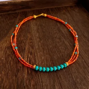 Three-layer vintage beaded necklace with red agate, turquoise and gold metal accents