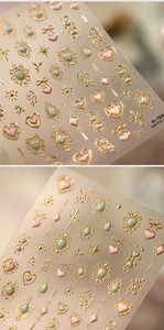 Details der geprägten 3D-Nagelsticker mit Herz- und Sternmotiven und Goldrand