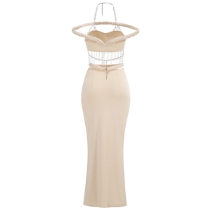 Close-up of off-shoulder crop top with woven knot details and metal chain decor