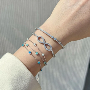 Macro shot of S925 sterling silver Mobius infinity bracelet with blue opal and zircons