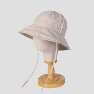 Beige wide brim sun hat for women with adjustable wind strap and foldable fabric