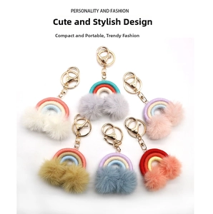 Close-up of rainbow plush ball keychains in six colors with gold alloy lobster clasps