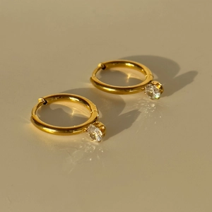 Close-up of 18k gold plated titanium earrings featuring sparkling round cubic zirconia
