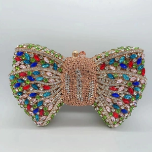 Macro shot of multi-color rhinestones and bow design on the luxury evening clutch bag