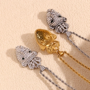 Detail of 18K gold plated leopard head pendant with crystals and twisted rope chain