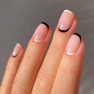 Classic French press-on nails in long oval shape with nude base and fine black-white tips