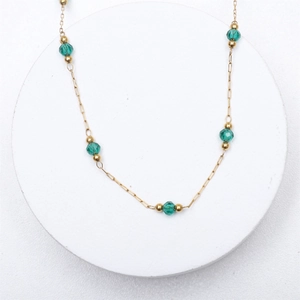 Beaded titanium steel necklace with green crystal accents and 18K gold-plated finish