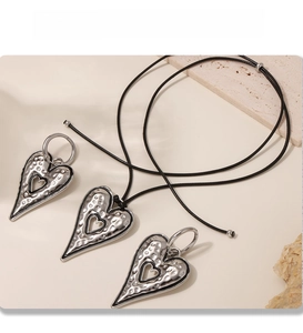 Detail of PVD plated silver hammer-textured heart pendant with black leather cord