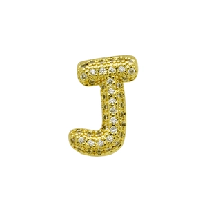 Close-up of golden letter J pendant with micro-paved cubic zirconia and grainy texture