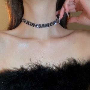 Close-up of black rhinestone choker necklace with pavé setting on a model's neck