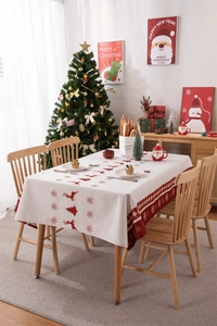 Detailed view of red reindeer and snowflake patterns on a festive Christmas tablecloth
