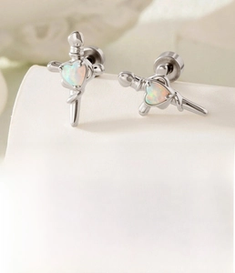 Macro shot of silver sword earrings with heart opal inlays and titanium steel studs