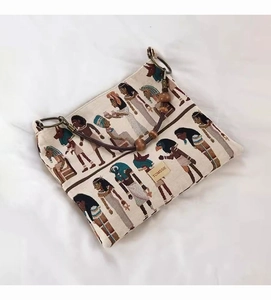 Detail of canvas tote with Egyptian jacquard pattern, wooden beads and metal ring strap
