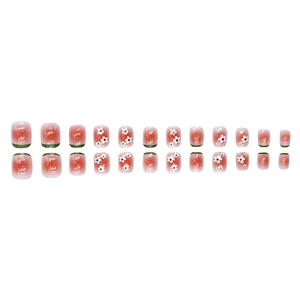 Short press-on nails with red-pink gradient, green tips and white daisy floral patterns