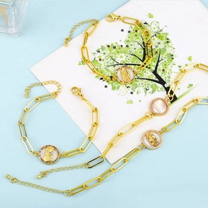 Detailed view of Virgin Mary and Saint Jude gold chain bracelets with mother of pearl