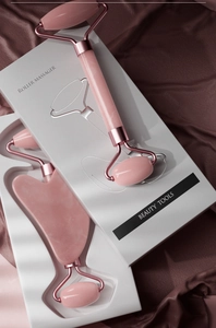 Pink facial jade roller and heart-shaped gua sha stone set in a premium gift box