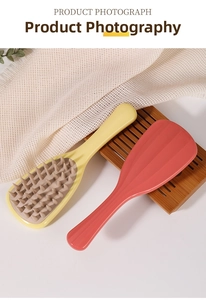 Detail of yellow and pink scalp massage brushes with soft silicone teeth and long handle