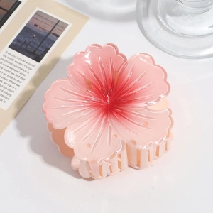 Detailed view of the gradient pink cherry blossom hair claw with matte resin texture