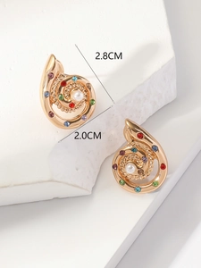 Detail view showing gold conch shell earrings with colorful gems and white faux pearls