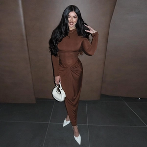 Close-up of brown long sleeve bodycon dress featuring a unique twist knot waist detail
