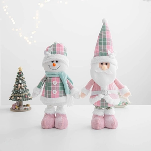 Detail of pink and grey plaid Christmas dolls featuring snowman and Santa Claus designs