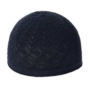 Detailed macro view of dark blue knitted kufi hat with breathable mesh pattern