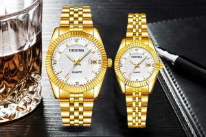 Close-up of gold couple watches with fluted bezel and leather strap in luxury setting