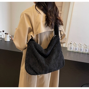 Detail of black corduroy tote bag showing thick texture and large capacity for women