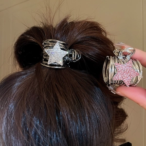 Close-up of Y2K star hair claw clip with rhinestones in silver and black metal