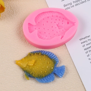 Detail view of pink silicone fish mold with textured ocean mermaid tail resin artwork