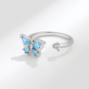 Adjustable silver butterfly spinner ring with blue crystals and sparkling stones