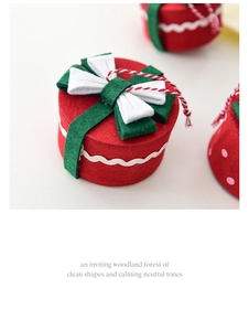 Detail of red felt Christmas gift box ornament with green ribbon and white bow