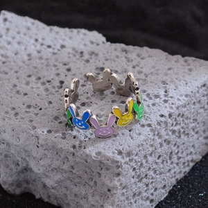 Colorful enamel rabbit open ring on grey volcanic rock with high quality lighting