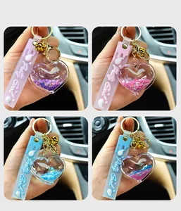 Close-up detail of heart-shaped liquid quicksand keychain with shiny glitter and bell