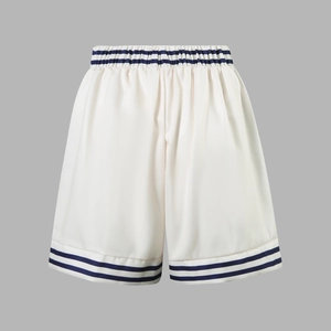 Detail of white athletic shorts with navy blue stripes and elastic waist for women