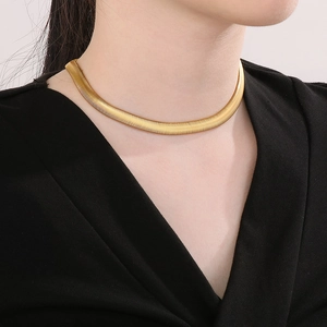 Minimalist gold-plated snake bone necklace shown on model for stylish layering