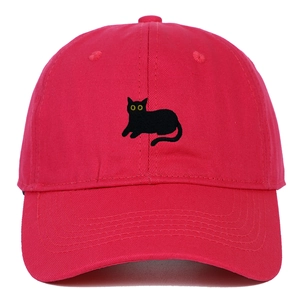 Close-up of a bright red cotton baseball cap featuring detailed black cat embroidery