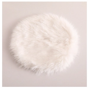 Detailed texture of white faux fur Christmas tree skirt with soft plush circular design