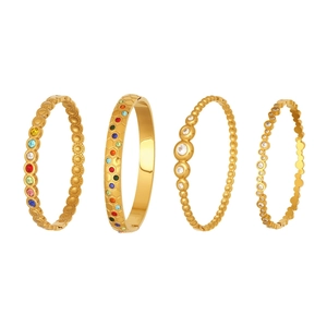 Stack of gold honeycomb bangles with colorful zircon stones in a luxury design
