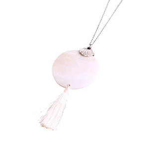 Minimalist silver chain necklace featuring white shell pendant and tassel detail