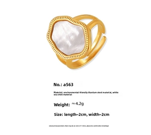 Macro detail of 18k gold plated titanium ring featuring white sea shell and beaded edges